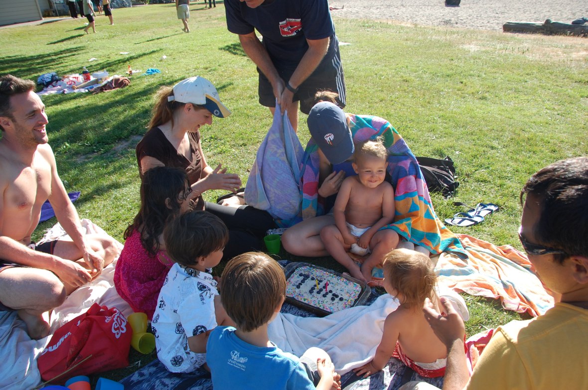 Joy after blowing out the 2 candles on his birthcake Name spelled with blueberries